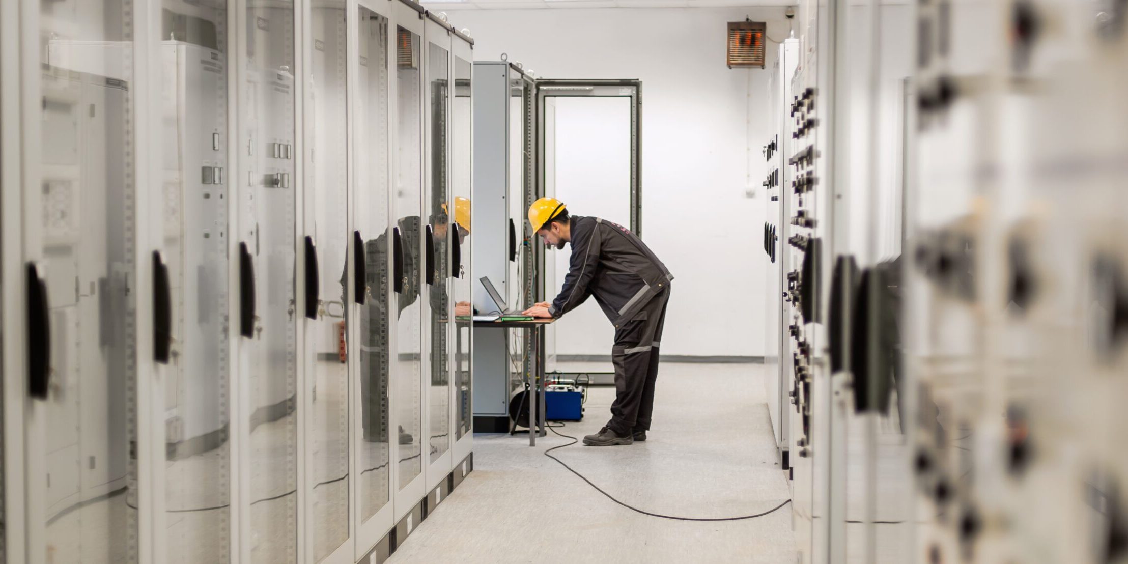 Field service engineer inspect relay protection system with laptop comput