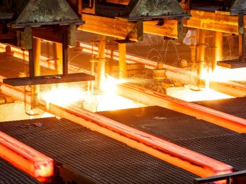 hot steel on conveyor Close shot in steel mill